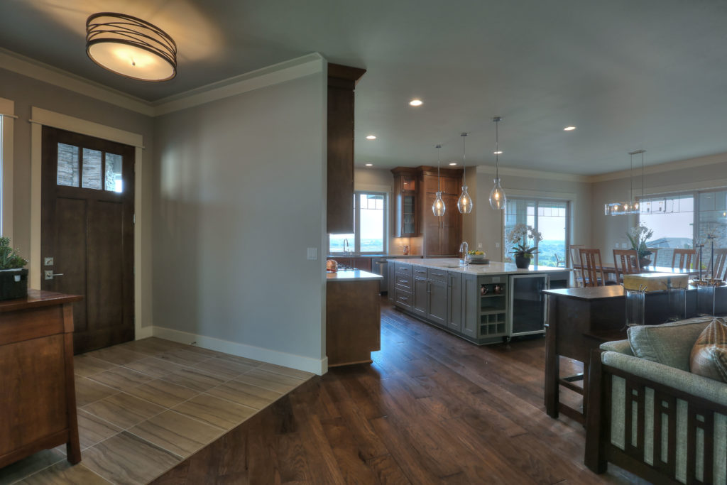 Open concept kitchen design, family room and main front door.