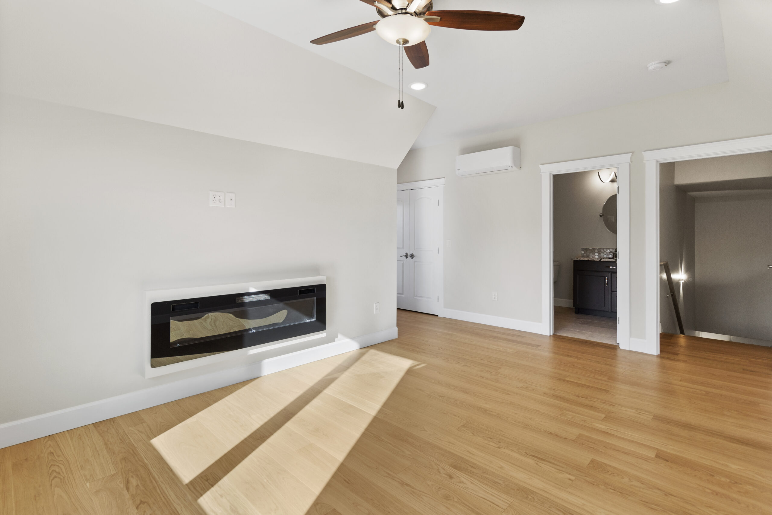 Empty living area, featuring fireplace in a modern home.